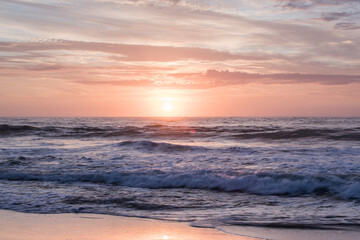 Fototapeta na wymiar Sunrise over slow motion blurred water 