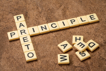 Pareto principle crossword in ivory letters against textured handmade bark paper, business,...