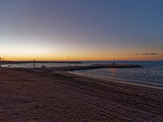 view of the sea and Lamppost on the Pedregalejo Beach at dusk