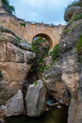 Fototapeta na wymiar Low angle view of Old Bridge of Ronda, Spain