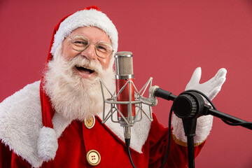 Santa Claus singing or speaking in a studio microphone. Merry Christmas. Broadcaster. Announcer....
