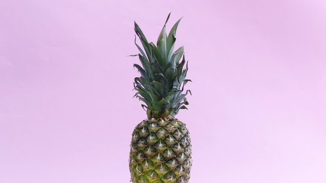 Rotating pineapple on pastel pink theme