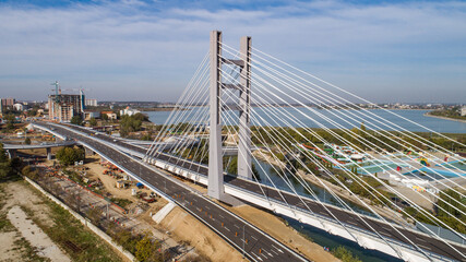 Obraz premium Aerial view of the Ciurel Passage Suspended Bridge on a sunny day.