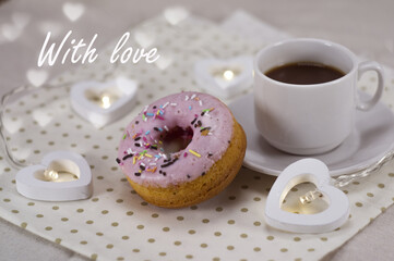 on a napkin: a cup of coffee and a donut with pink icing, light bulbs in the form of hearts. the inscription 