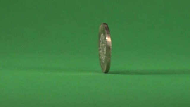 10 Mexican pesos slowly spinning on chroma background.