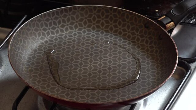 Oil being poured on a pan.