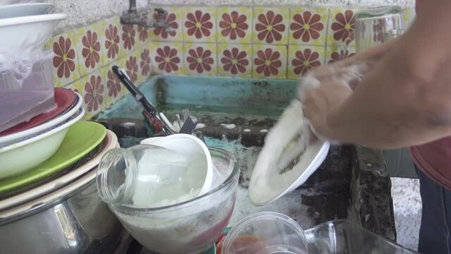 A woman washing the dishes.