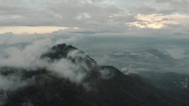 Drone aerial flying high over cloudy misty mountains in Guatemala