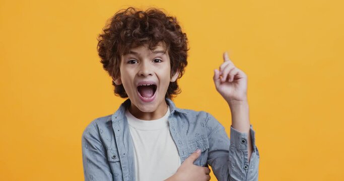 Kids fantasy and creativity concept. Adorable pensive boy thinking, feeling inspired and got incredible idea