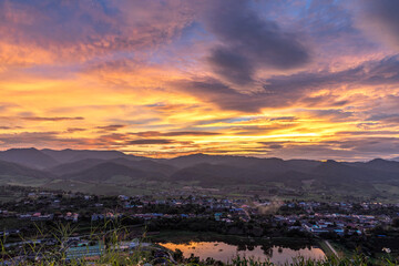 Fototapeta premium View of village with lake at morning sunrise sky.