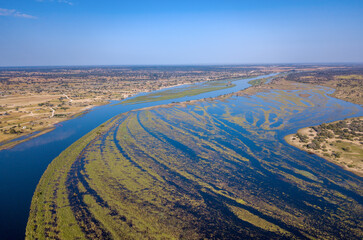 Okavango delta landscape on Namibia and Angola border. Aerial landscape of famous river with shore...