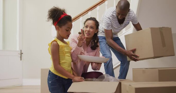 African American couple and their daughter moving into new house