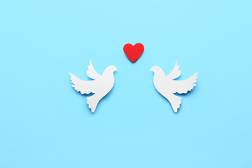 Paper doves and heart on color background. International Day of Peace