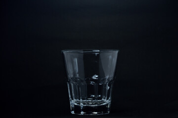 A 100 ml transparent glass on a black background