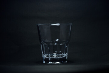 A 100 ml transparent glass on a black background