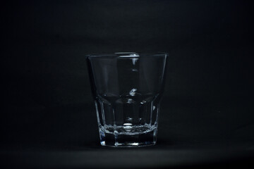 A 100 ml transparent glass on a black background