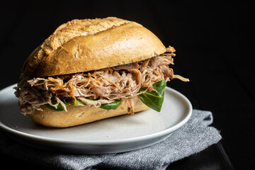 Sandwich with pulled meat.