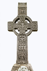Drogheda, Ireland - July 15, 2020: View of West face of Muiredach's high celtic cross on white background at early Christian monastic settlement Monasterboice founded in 5th century. - 387074099