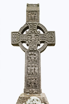 Drogheda, Ireland - July 15, 2020: View of West face of Muiredach's high celtic cross on white background at early Christian monastic settlement Monasterboice founded in 5th century.