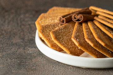 Cinnamon sugar  crackers on white plate concrete background.