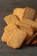 Cinnamon sugar  crackers  and cinnamon sticks on concrete background. Copy space