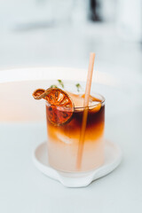 Cold drink in a glass Iced coffee in a glass at a white cafe
