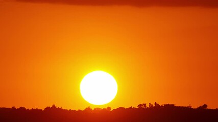 Time Lapse of the sun setting behind some mountains