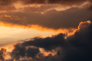 clouds with black clouds at sunset as background
