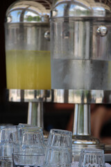 decanters with juice on the table and glasses