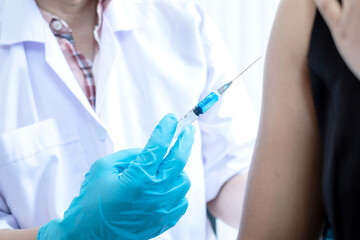Male doctors vaccinated with syringes to prevent epidemics at hospitals, health care, and medical concepts