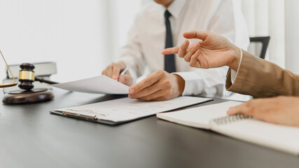 Counselor with legal documents discussing with client about legacy case.