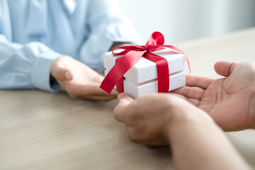 Gift box hand holding a gift box Glad to be the giver of surprise with excitement, the joy on the holidays, Christmas, birthdays, or Valentine's Day concept