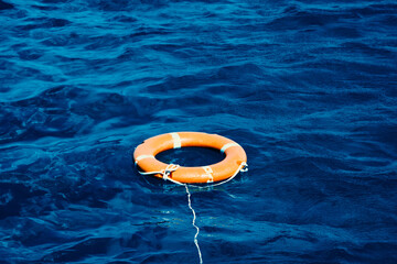 An Orange Lifebuoy Floating in the Middle of the Ocean