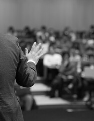 Business coach. Team leader teaches employees at a business meeting in a conference room. Speaker...