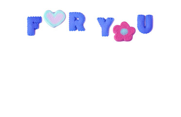 The words FOR YOU spelled with blue alphabet shaped cookies and pink marshmallow on white background