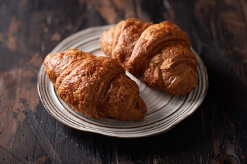 fresh croissants on a ceramic plate