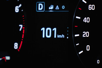 Speedometer in the car on the dashboard. The car's speedometer shows 101 mph