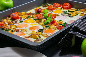 Fried Eggs with italian vegetables on a baking tray