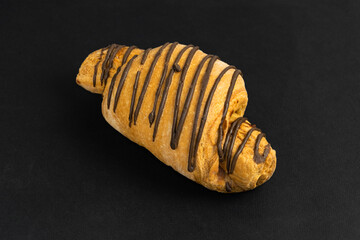 pastries with chocolate close-up. on a black background