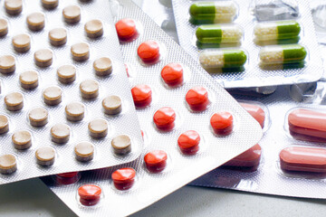 Obraz na płótnie Canvas Different Colored tablets and capsules Packed in blisters. Pharmaceutical or medical background