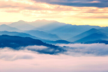 Fototapeta premium Scenic view of mountain and fog in morning sunrise, Landscape of natural