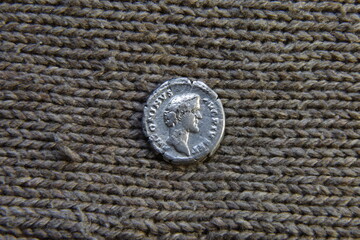 antique roman silver coin on the table