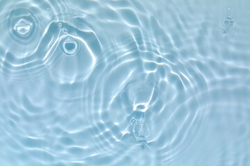 De-focused blurred transparent blue colored clear calm water surface texture with splashes and...