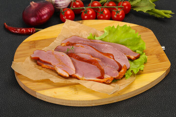 Sliced smoked duck breast served salad
