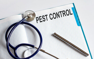 Paper with text PEST CONTROL on table with stethoscope