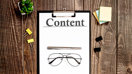 CONTENT text form on a wooden table.