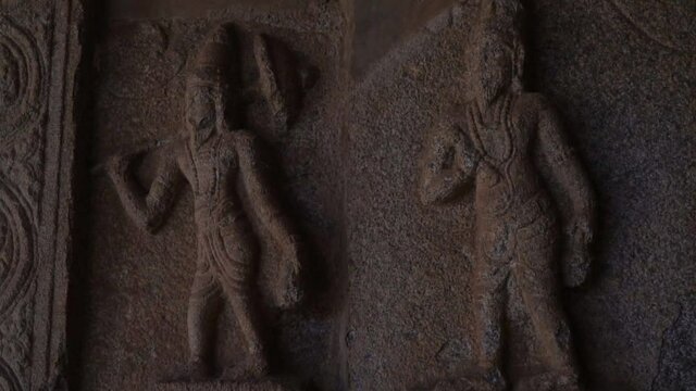 Images of people carved on a stone wall in a temple in the Indian city of Hampi