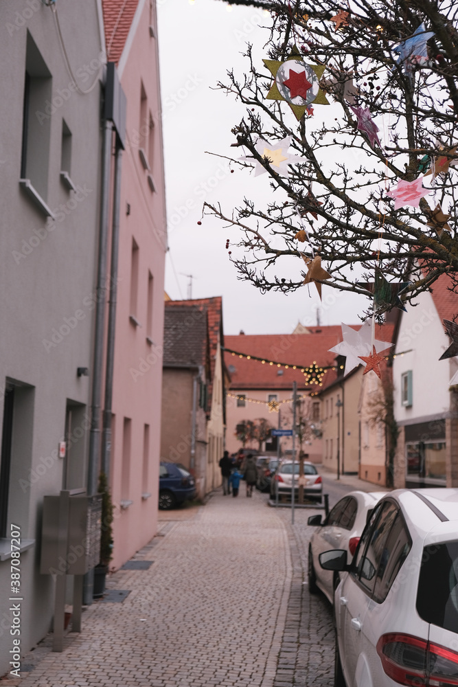 Wall mural Christmas and New Year in Europe. Christmas holidays in Germany.festive Christmas decor on the streets of Europe. European Houses with red roofs.traditional German style fachwerk houses background. 