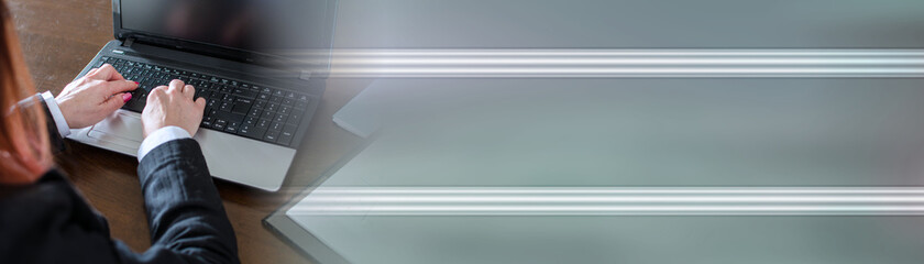 Businesswoman typing on a laptop; panoramic banner