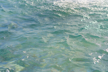 water surface in a city fountain with sunlight as a background